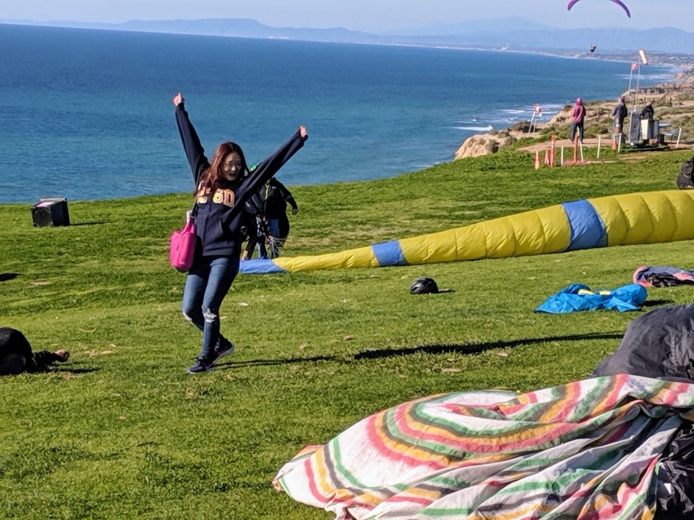 FGL student celebrating at the Torrey Pines Gliderport overlooking the Pacific