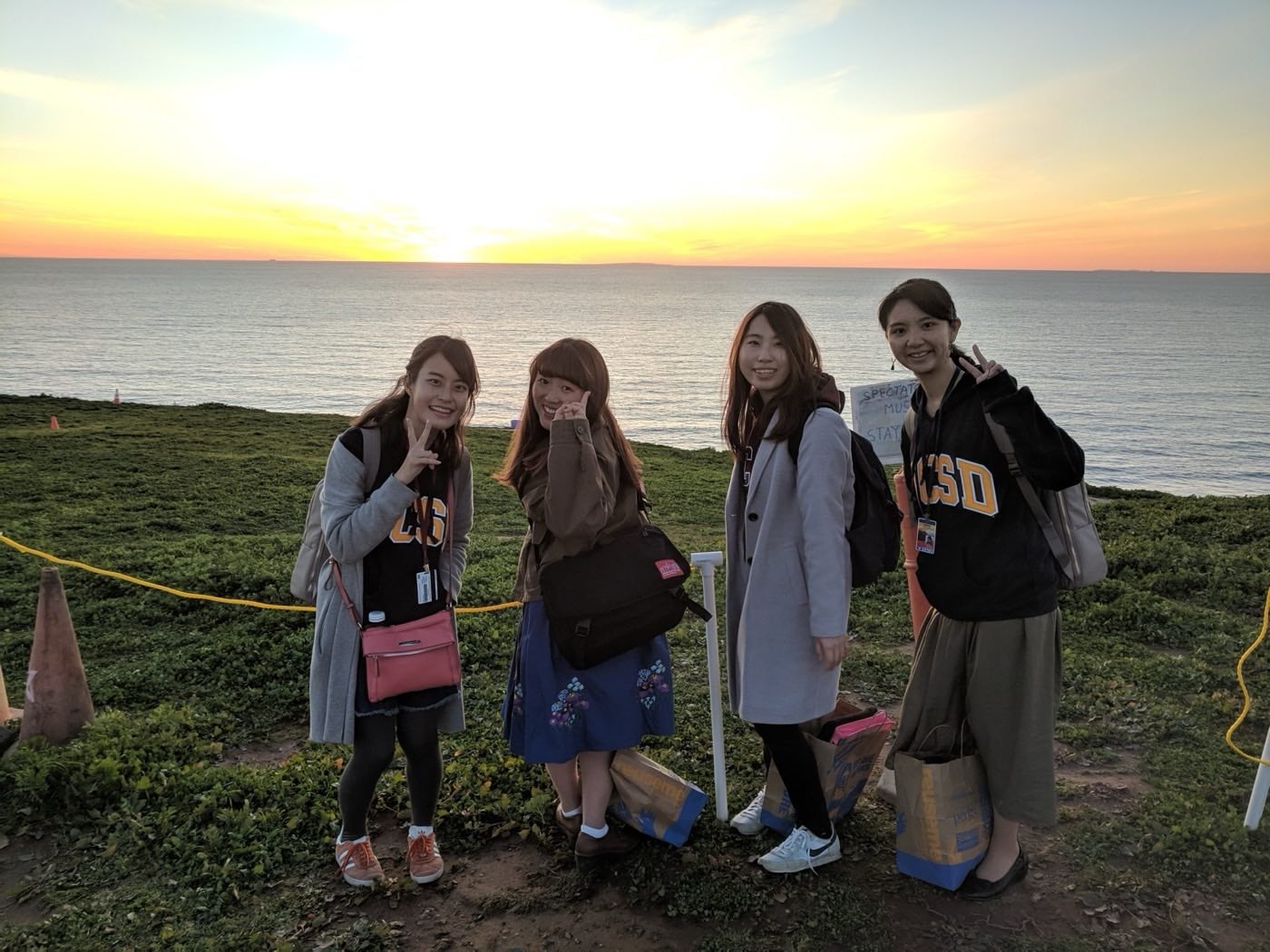FGL students posing together at sunset on the UC San Diego coastline